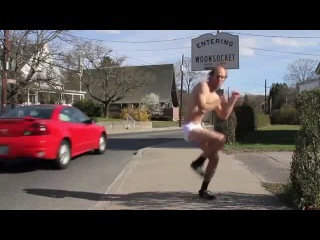 a man in shorts dances on the street
